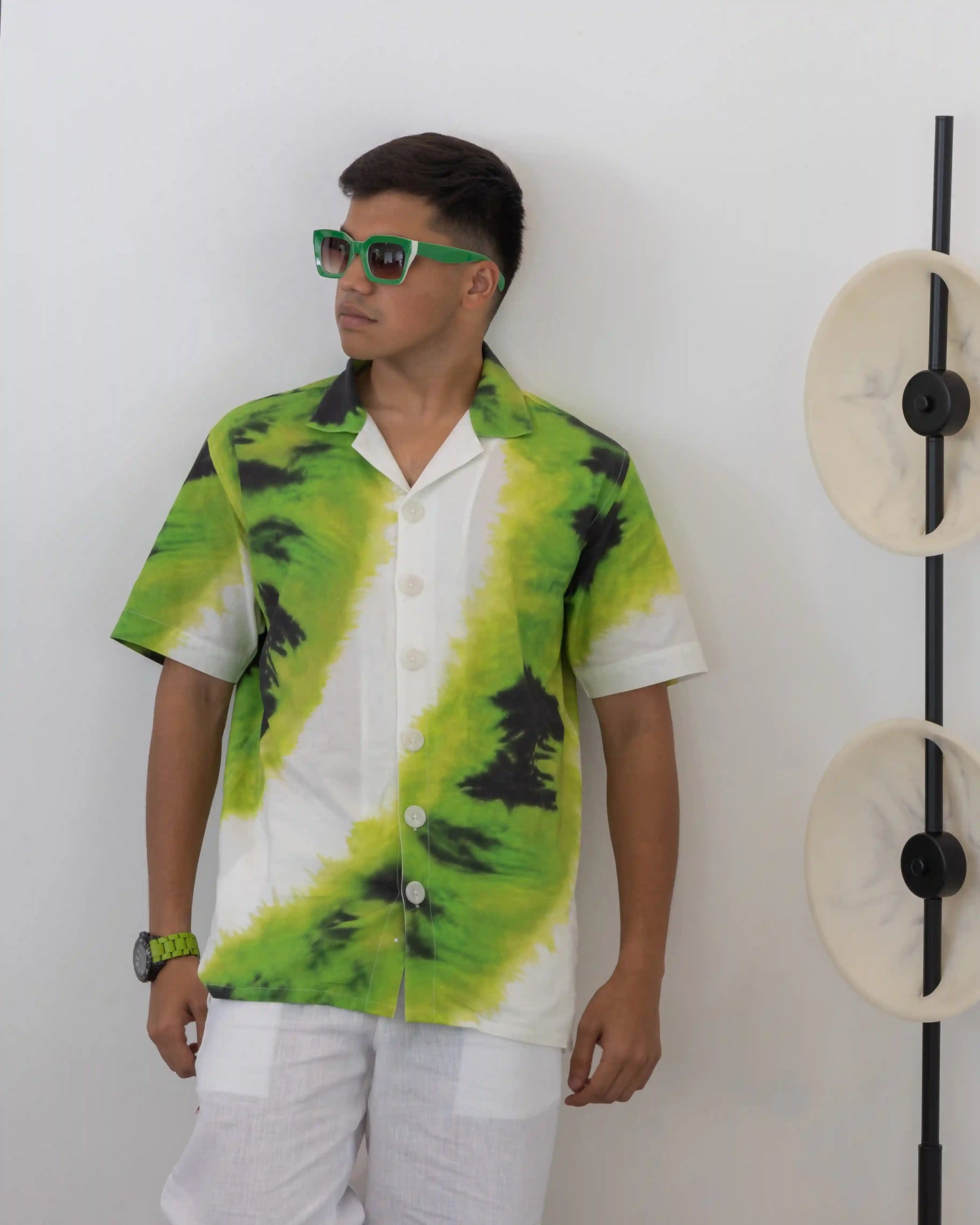 Model wearing NAD's abstract green black cotton shirt for men.