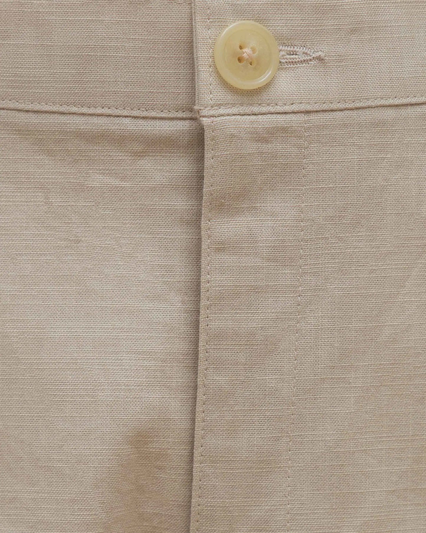 Close-up of NAD's beige cotton pants for men.