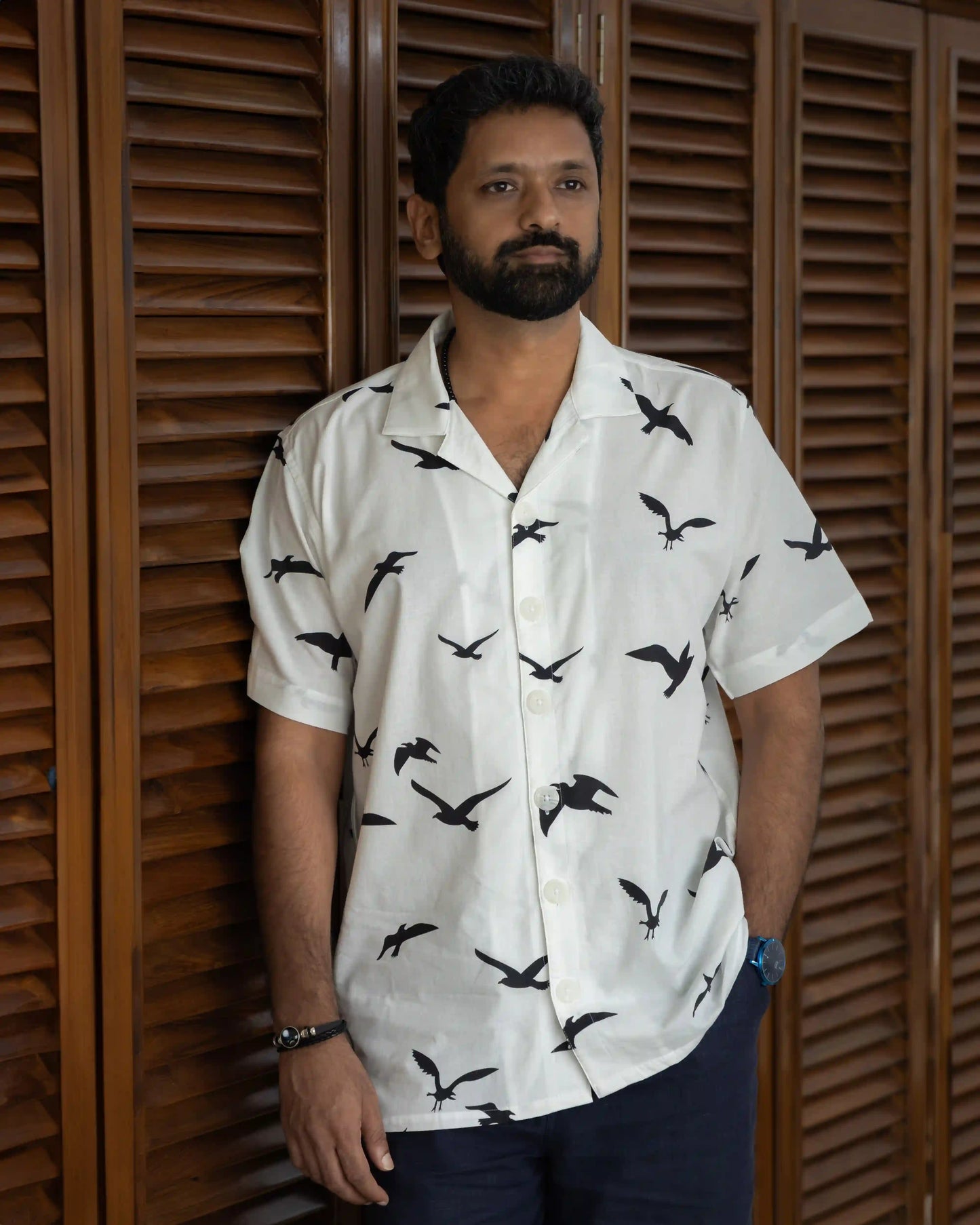 Model in NAD's black birds print shirt for men.