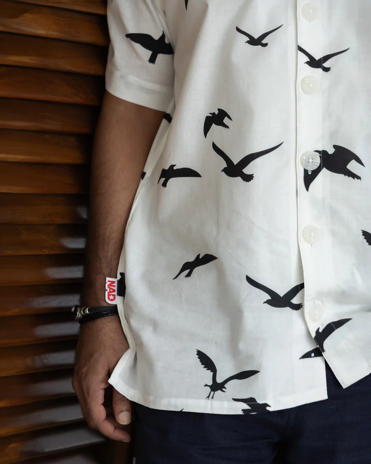 Close-up image of NAD's black birds print shirt for men, focusing on the design details.