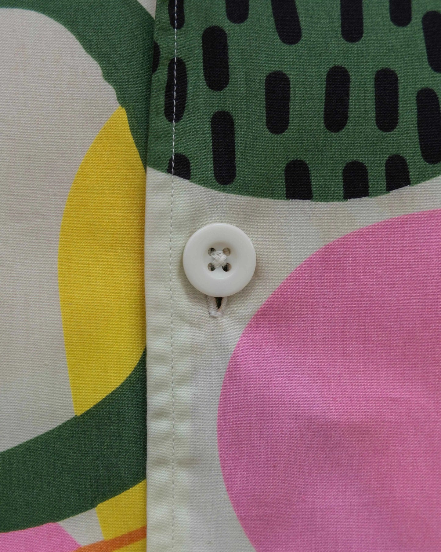 Close-up of a distorted circles poplin printed shirt for men showcasing a vibrant pattern.