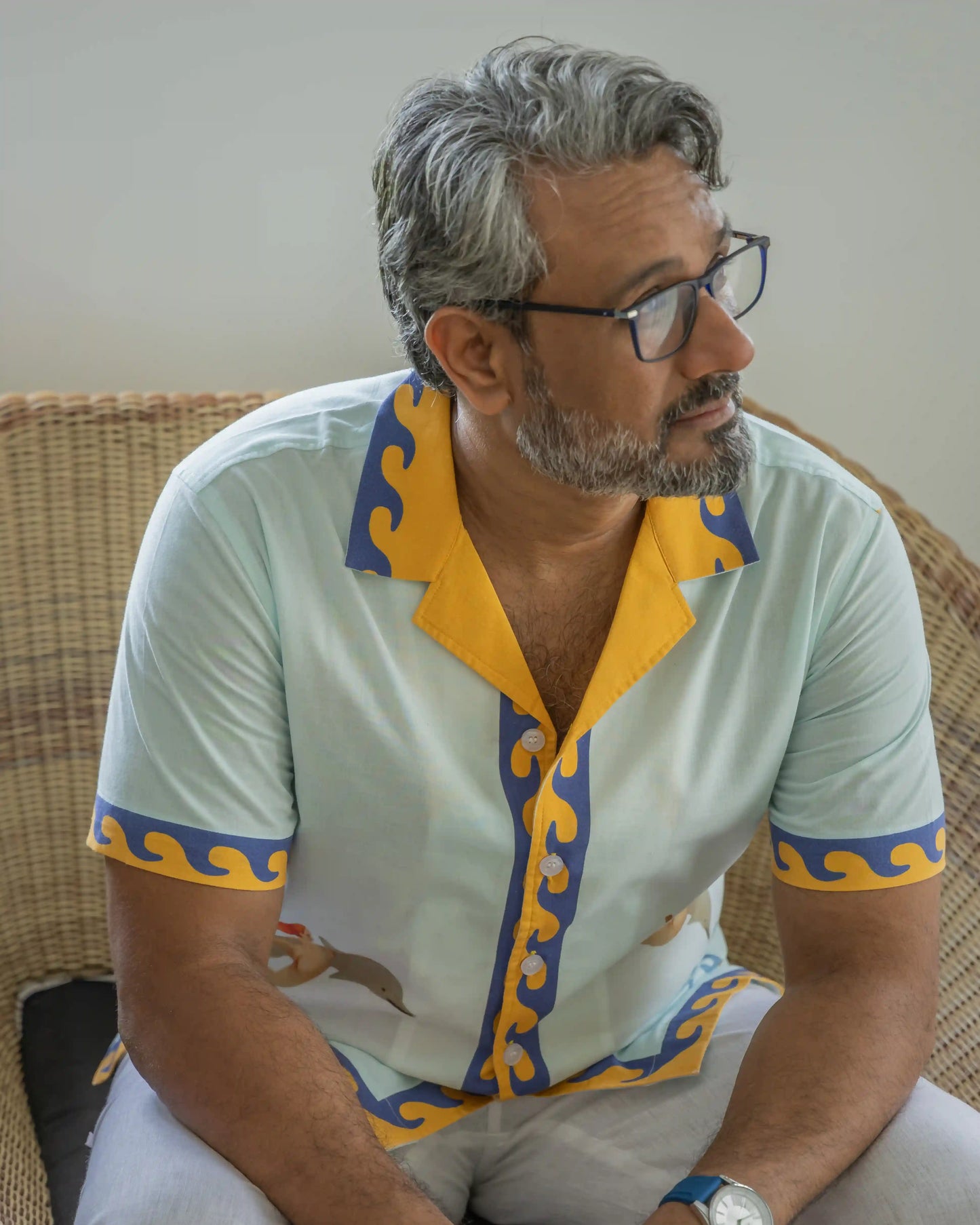 Model in NAD's jumping dolphin printed multi-coloured shirt for men.