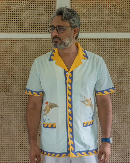 Model wearing NAD's jumping dolphins printed multi colour shirt for men.