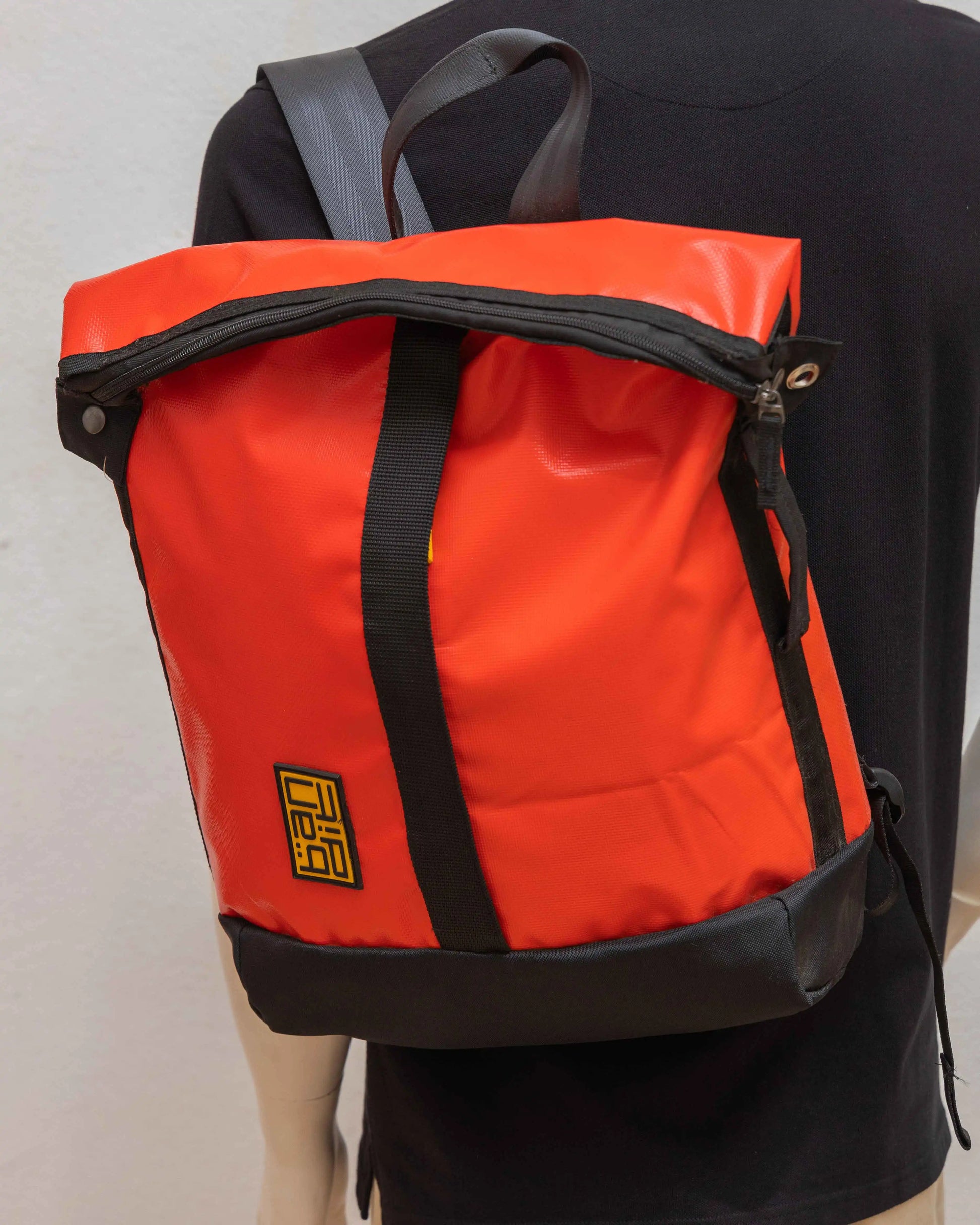 Mannequin displaying NAD's red backpack for men.