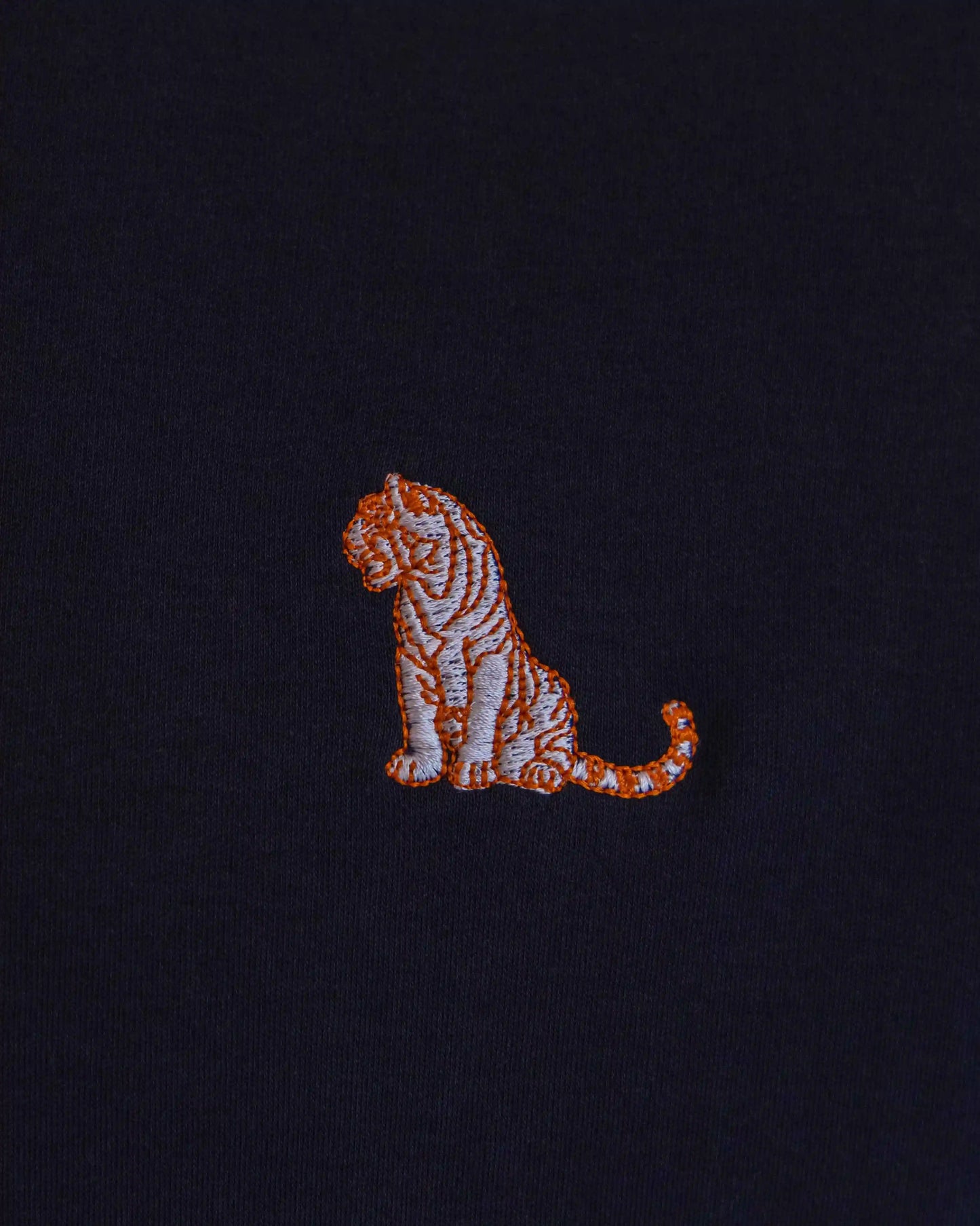 Embroidered tiger design on a navy blue cotton jersey men's crew t-shirt by NAD.