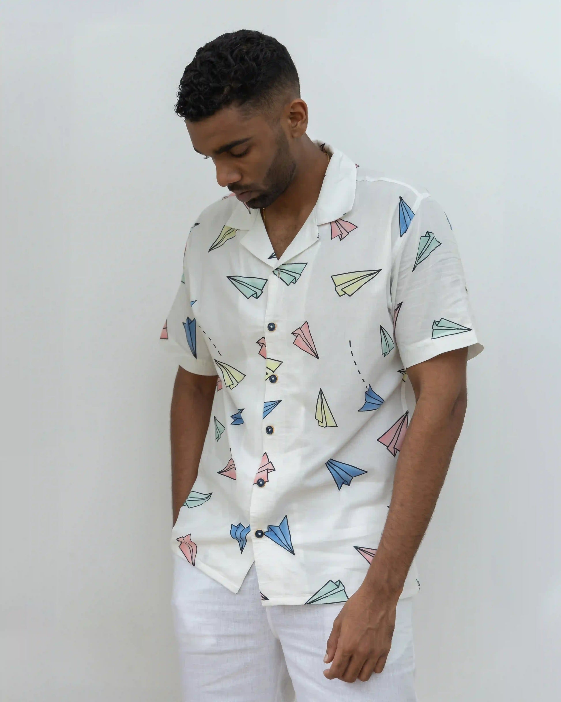 Model dressed in NAD's paper plane print shirt for men.