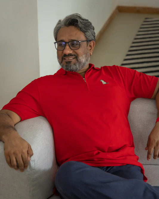 Model in relaxing in NAD's red cotton polo t-shirt for men.