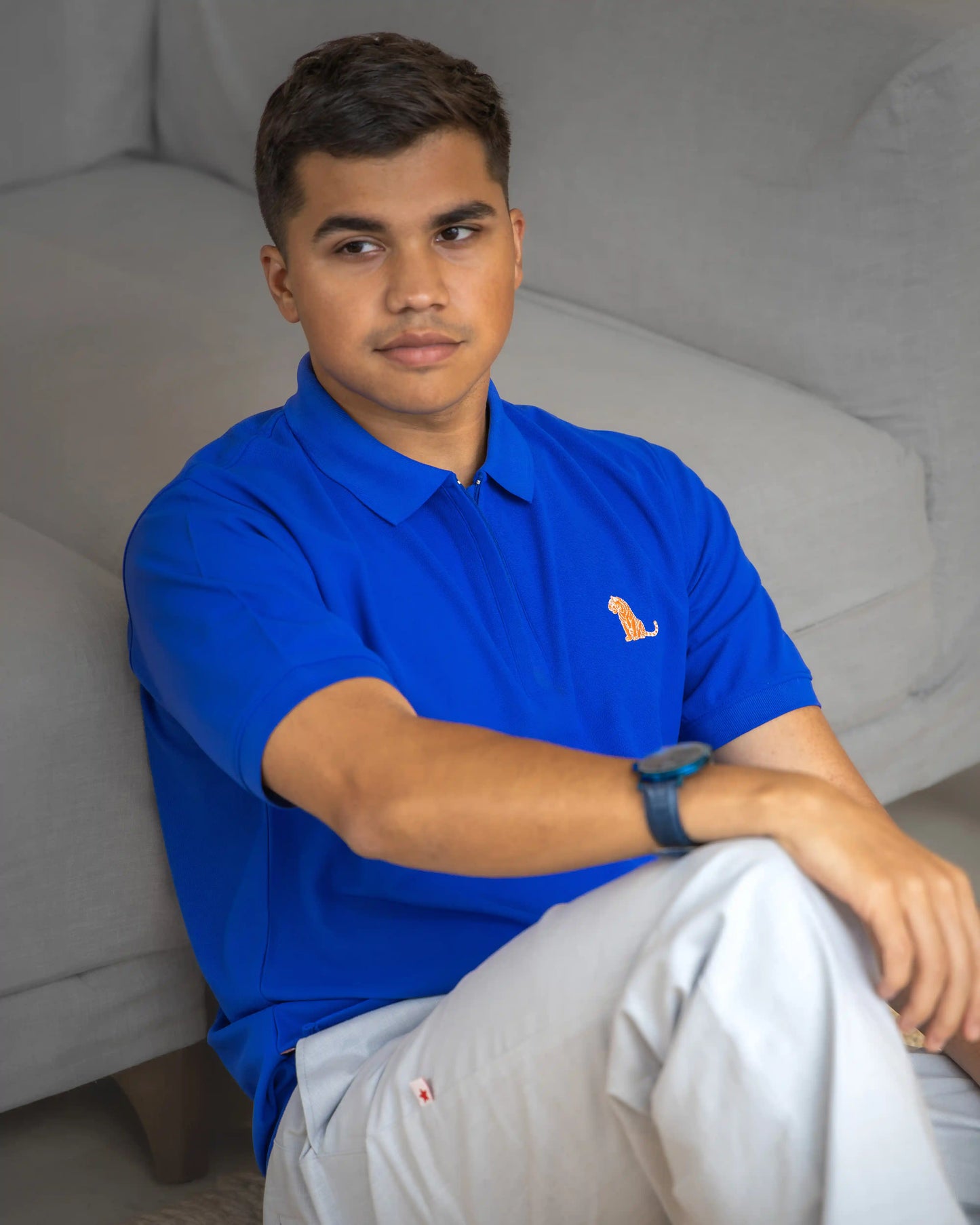 Model in a royal blue cotton polo t-shirt for men by NAD.