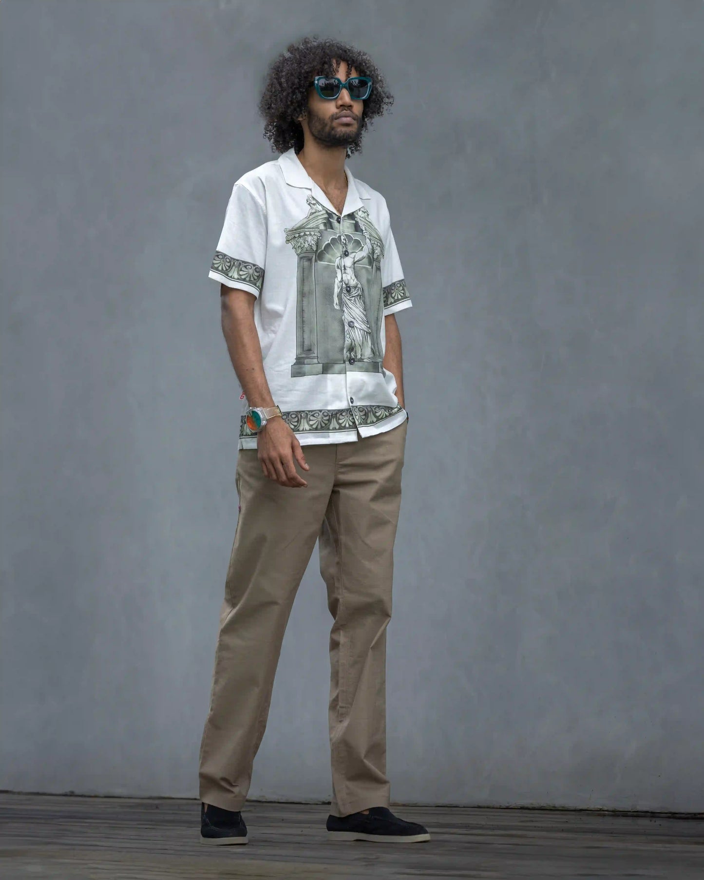 Model wearing NAD's Zeus print shirt for men paired with brown pants.