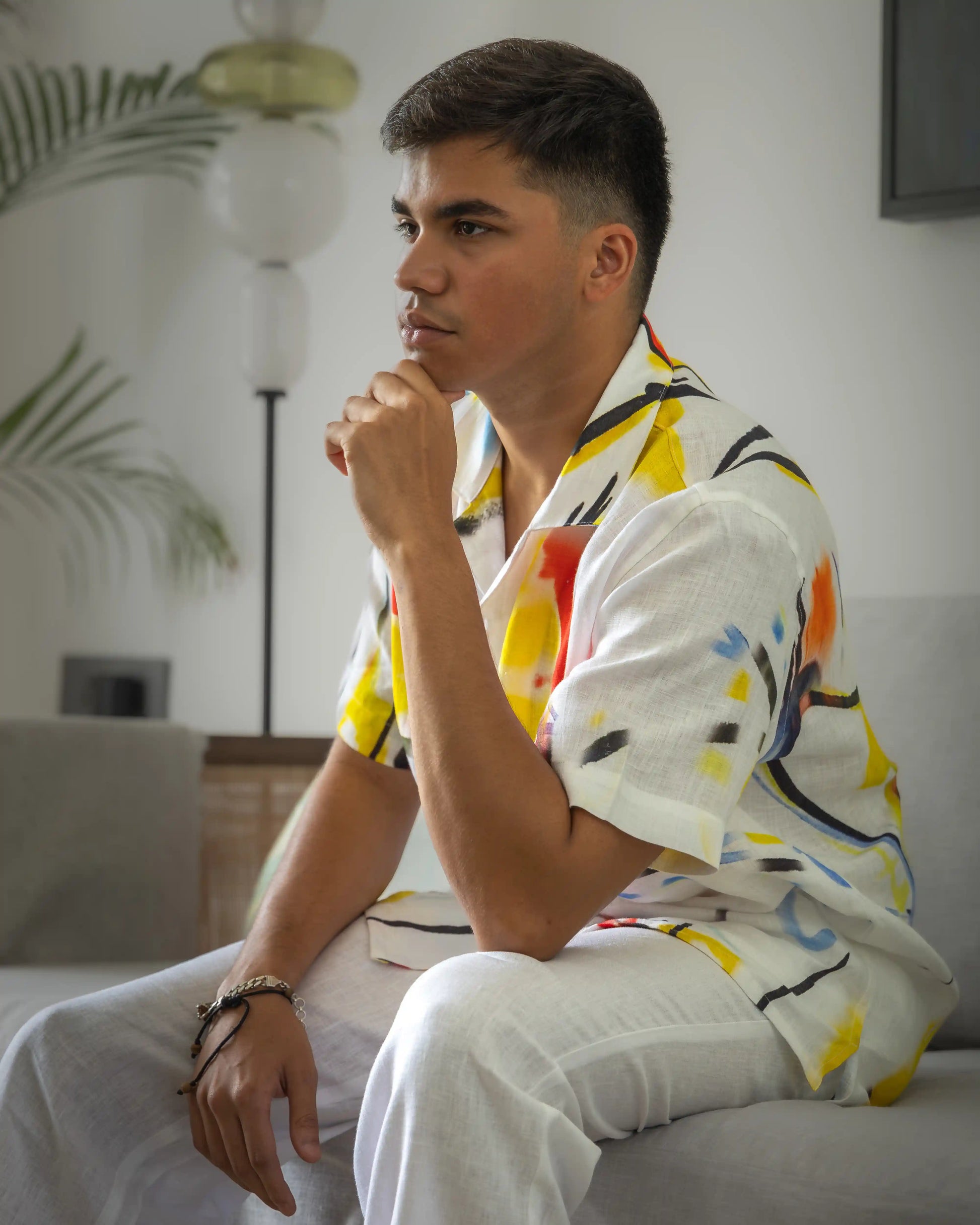 Model in NAD's abstract linen shirt for men paired with white linen pants.