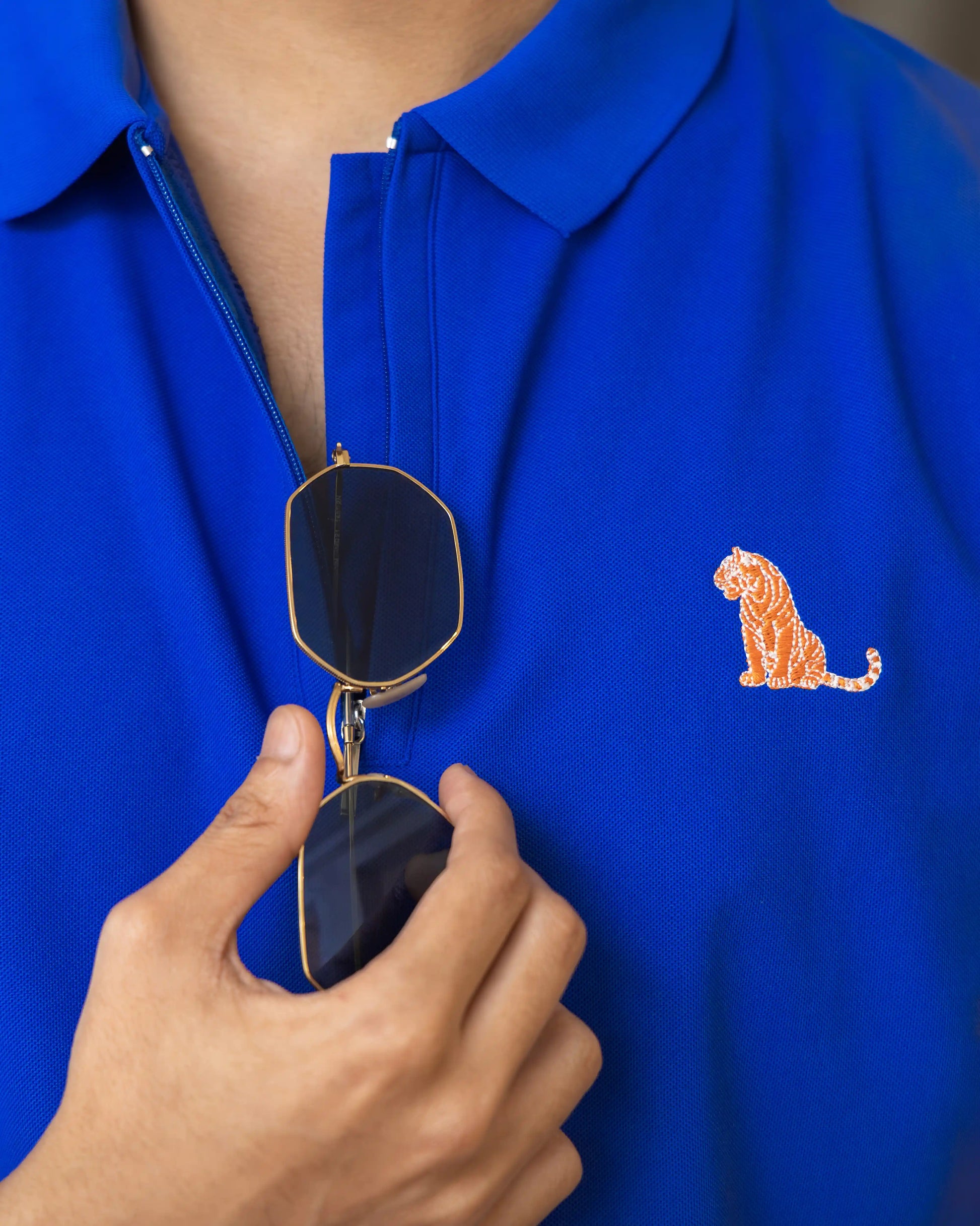 Close-up image of NAD's royal blue cotton polo t-shirt for men, focusing on the zipper and design details.