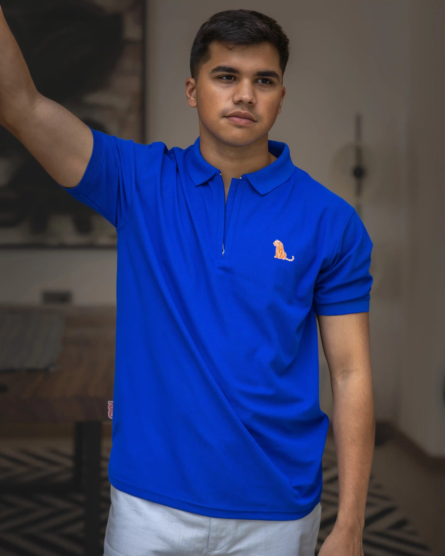 Model in NAD's royal blue cotton polo t-shirt for men. 