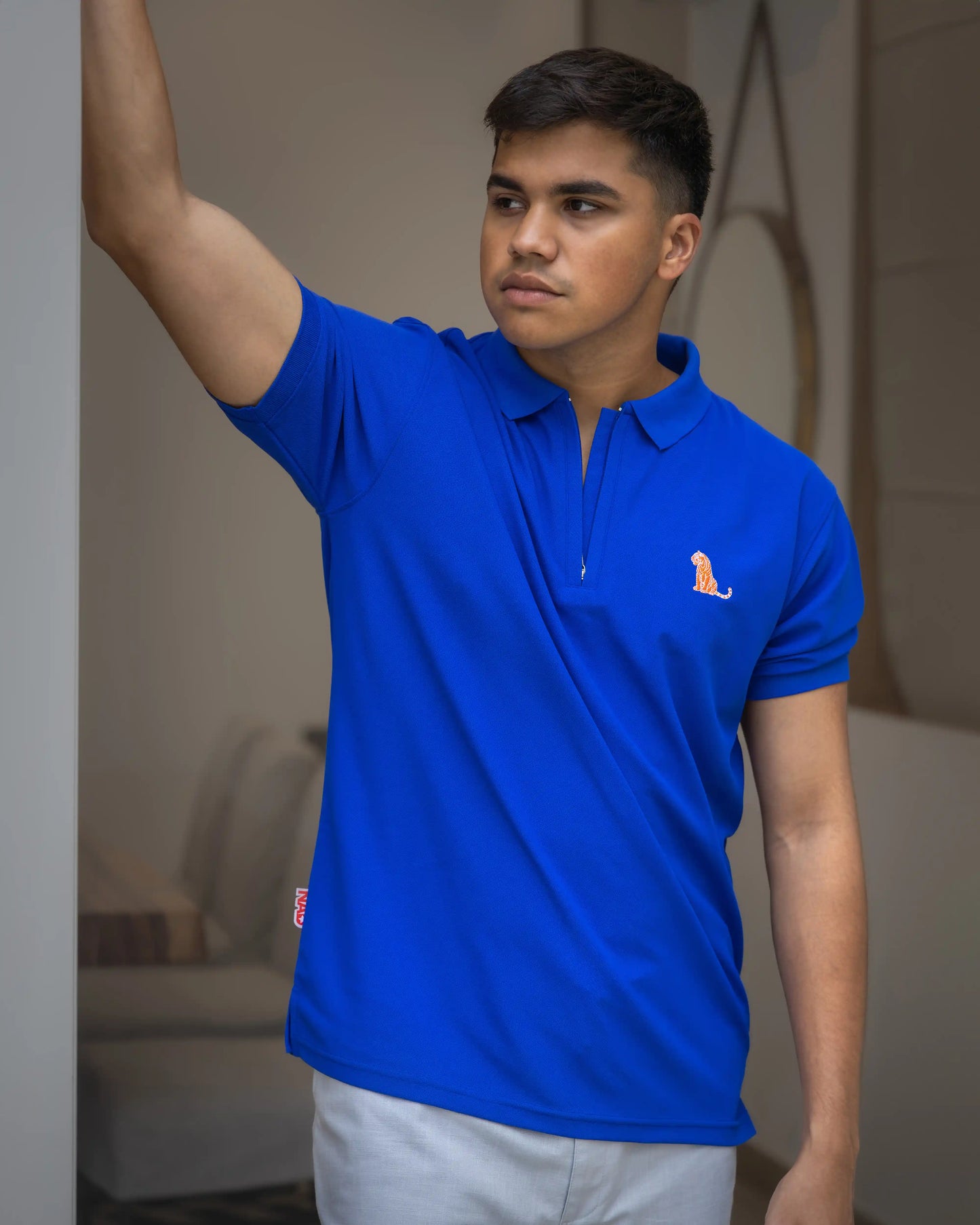 Model wearing NAD's royal blue cotton polo t-shirt for men.